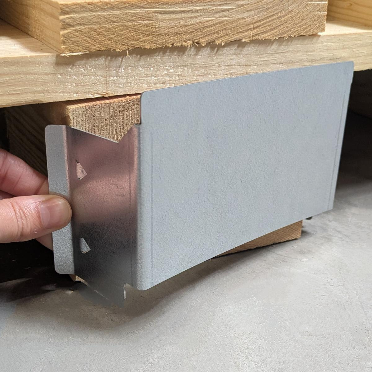 Metal pallet clamp on a loaded pallet - side view